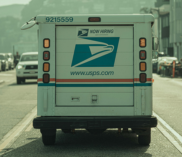 Photo by Arnet Xavier: https://www.pexels.com/photo/a-mail-truck-driving-down-the-road-with-a-post-office-logo-on-it-16363850/